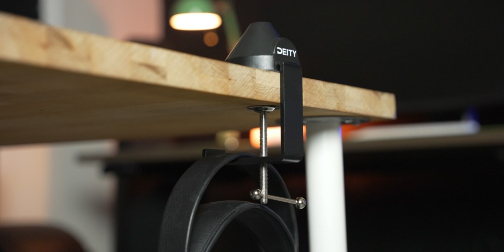 The Deity VO-7U podcast kit has a headphone mount built in on the base.