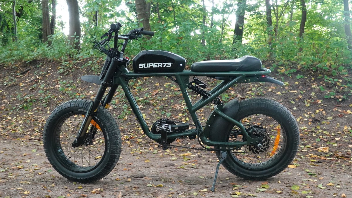 a motorcycle parked next to a forest