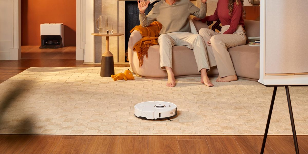 a person sitting in a living room with a wooden floor