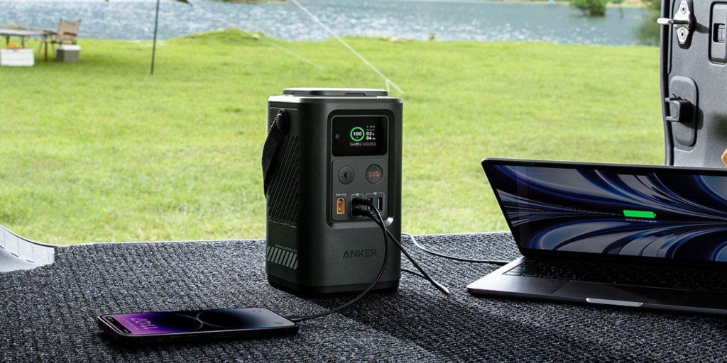 a computer sitting on top of a grass covered field