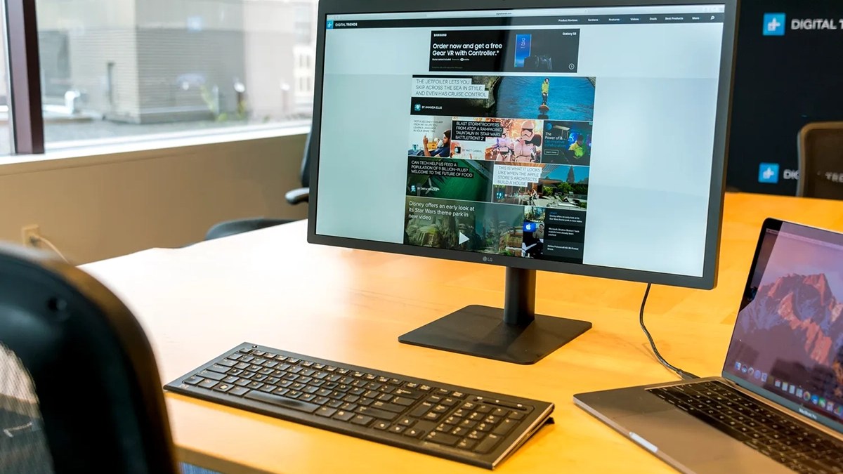 a desk with a laptop computer sitting on top of a table