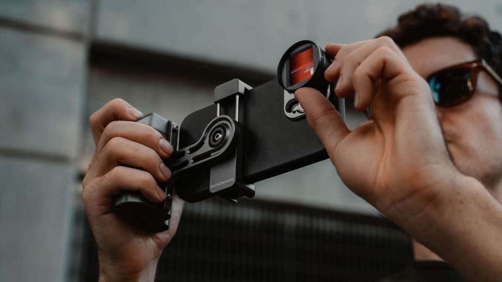 a hand holding a camera