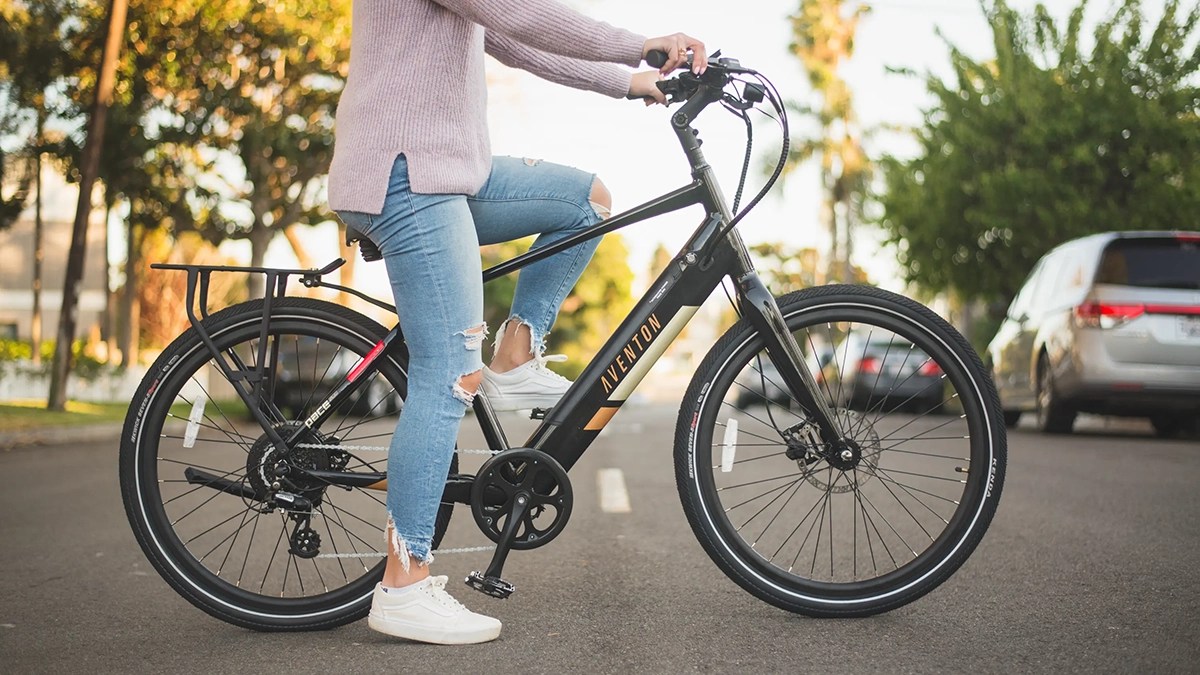 a woman riding on the back of a bicycle