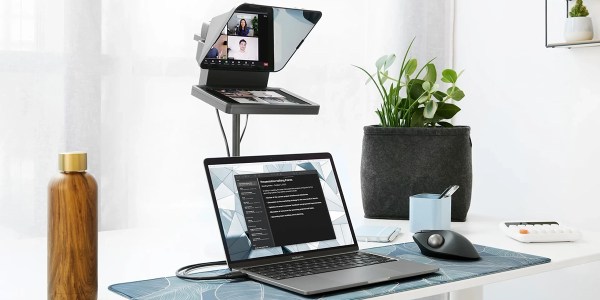 a desk with a laptop computer sitting on top of a table