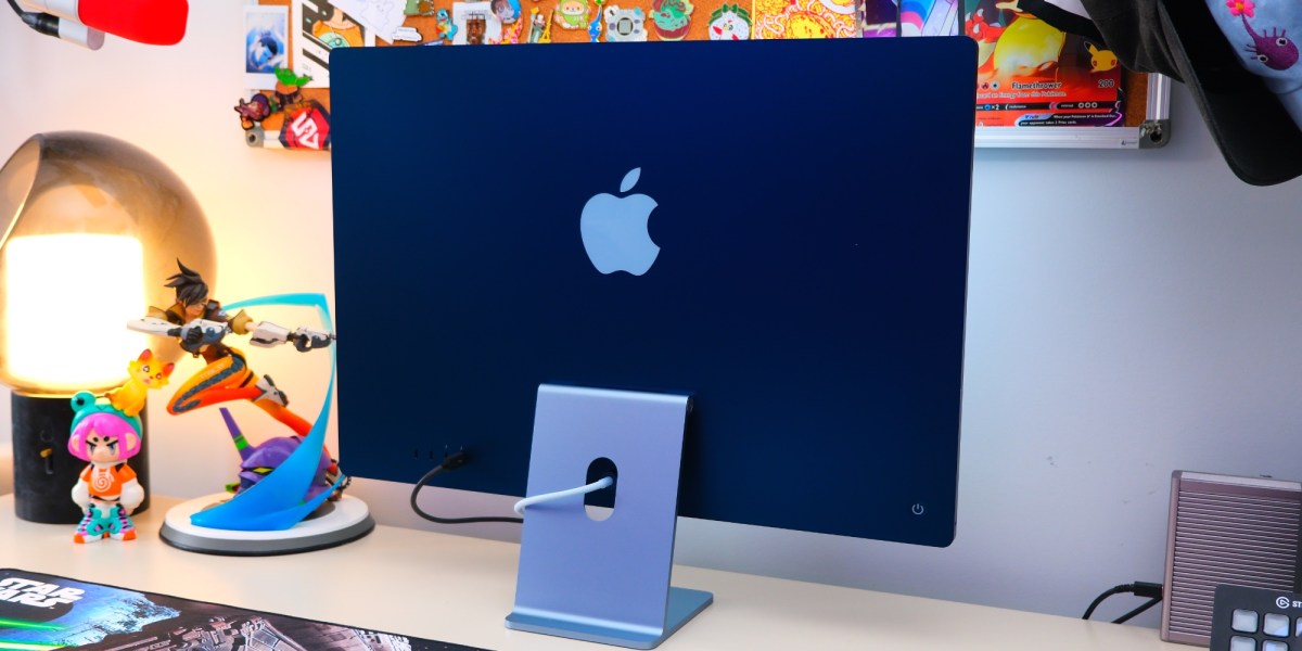 a desk with a laptop computer sitting on top of a table