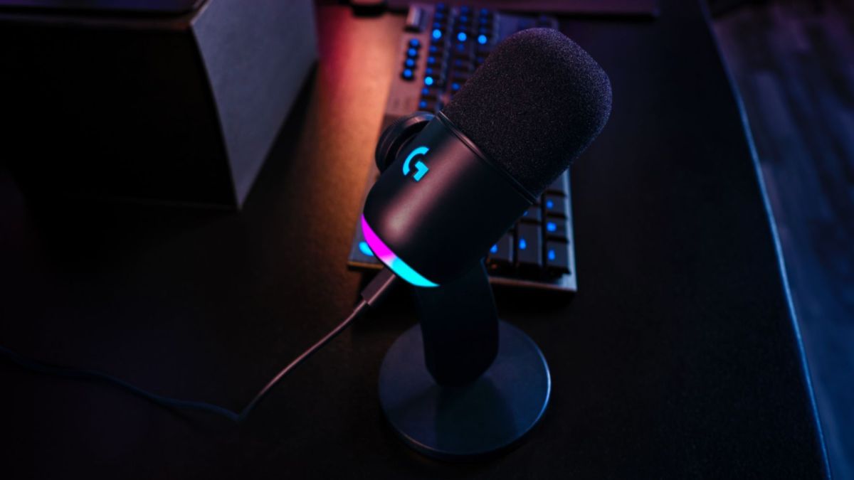 Logitech G Yeti GX mic with RGB lighting kept on a table next to other peripherals.