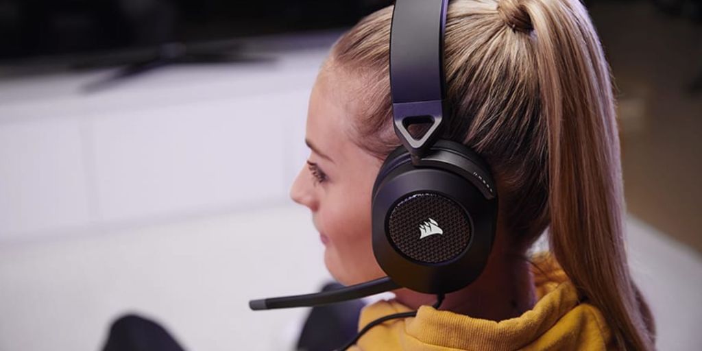 Image showing a person wearing Corsair's HS65 gaming headset.