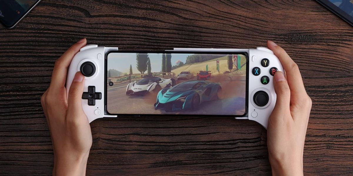 Image showing a person using 8Bitdo's Ultimate Mobile controller in white.