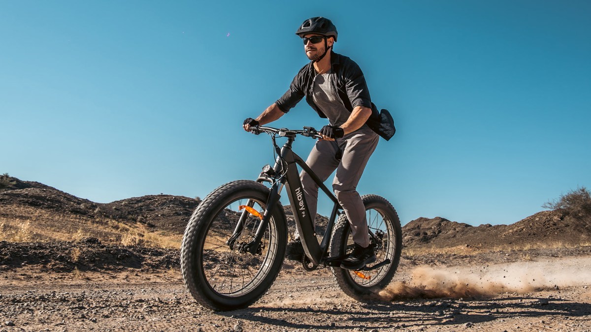 a man riding a bike on a dirt road