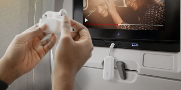 Image showing a person using Twelve South's AirFly Pro Deluxe Bluetooth transmitter.