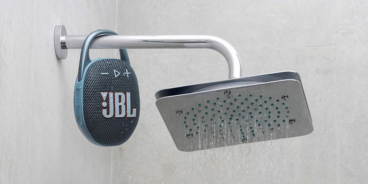 Image showing JBL's Clip 5 Bluetooth speaker hanging on a shower head.